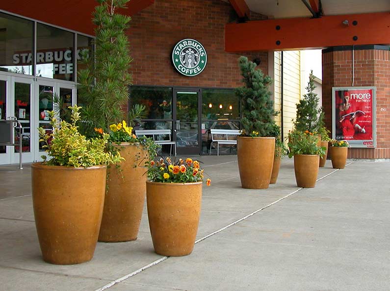 Colorful cement planter pots beautifying the a mall's entrance.