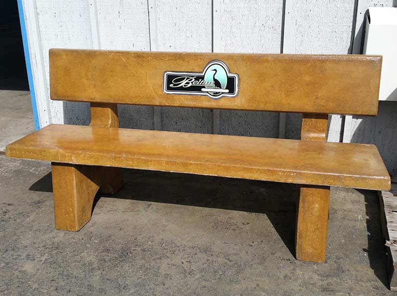 Straw stained concrete bench with company logo.