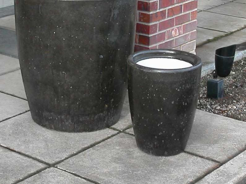 Concrete ash urns and commercial cement cigarette receptacles.